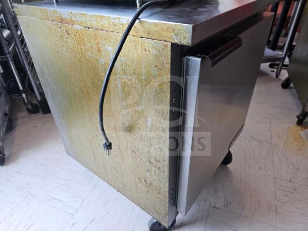 Beverage-Air WTR27A, 27" undercounter fridge; one solid door, visible wear and rust, plug cable shown.