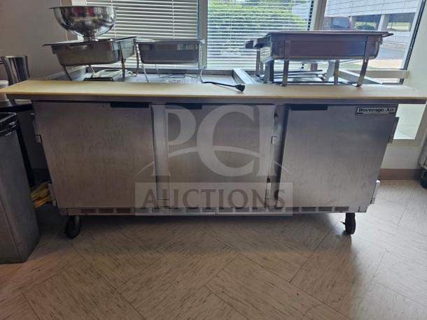 Beverage-Air 72" refrigerated salad bar with stainless steel finish, three doors, caster wheels, and visible branding label.