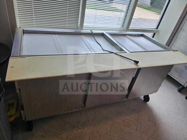 Beverage-Air 72" refrigerated salad bar with dual sliding covers, sturdy metal frame, and power cord. Good condition.