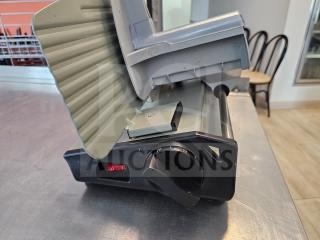 Sportsman Series meat slicer, used condition, gray and black finish, adjustable thickness dial, resting on metal counter.