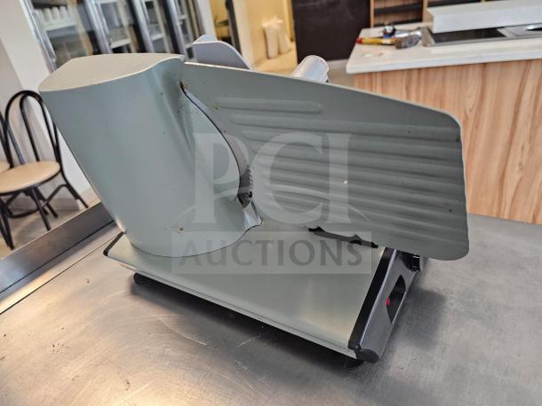 Sportsman Series meat slicer in fair condition, metallic finish. Features adjustable blade and sturdy base for precise slicing.