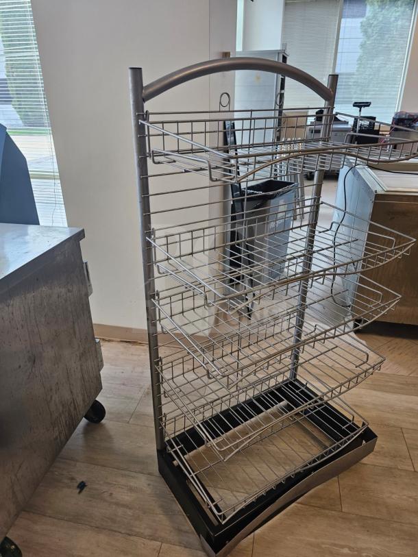 5-tier wire retail merchandising display with adjustable shelves, metal frame, and black base. Used condition, ideal for stores.