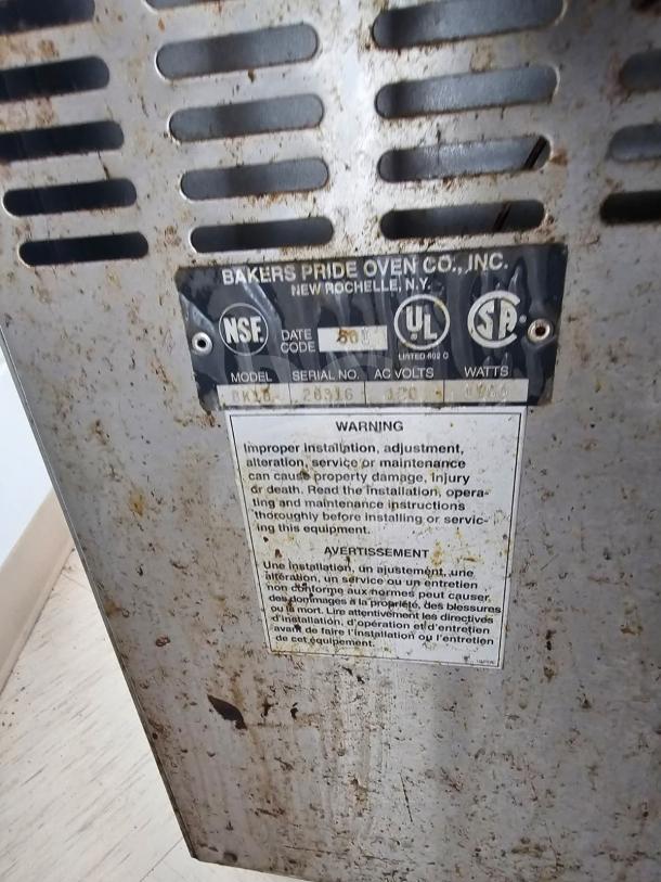 Bakers Pride electric countertop oven label showing model BK16, serial number 28336, warnings, and certification marks.