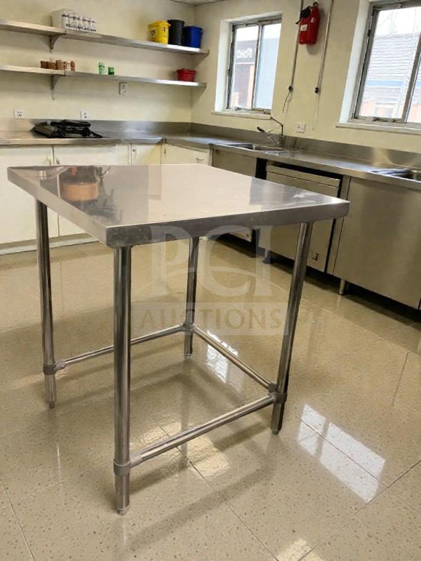 Stainless steel commercial prep table in superb condition, heavy-duty, fully inspected, ideal for professional kitchens.