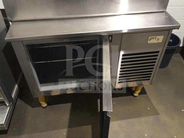 ICM Stainless SCSLC-1800 commercial refrigerated undercounter unit in immaculate condition, open door showing interior shelves, 120/220V.