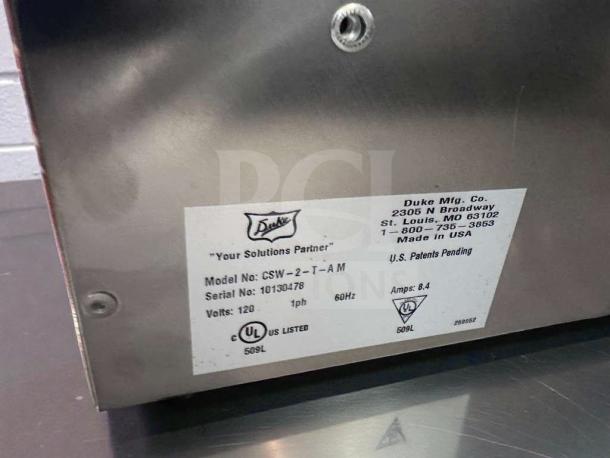 Label on Duke CSW-2-1-AM commercial soup warmer, UL listed, 2 wells, model details, and specifications shown.