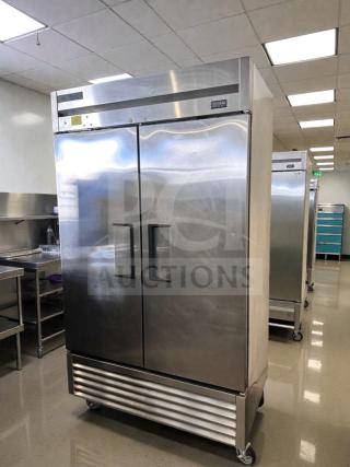 Commercial two-door reach-in refrigerator, stainless steel, bottom-mount, immaculate condition, fully tested and operational.