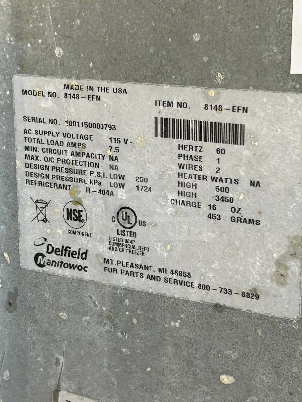 Silver tag on Delfield 8148-EFNP displaying model, serial number, voltage, and UL & NSF certification logos.