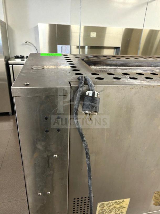 Duke Electric Conveyor Broiler Oven in immaculate condition. Features a durable exterior, power cord attached, and operational tags.