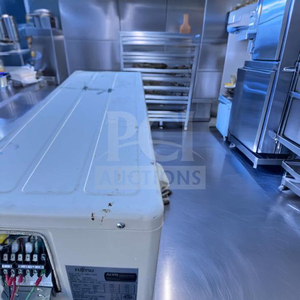 Elite condition Fujitsu AUU24RLB outdoor condenser unit, 24,000 BTU, 208/230V, fully operational, visible wiring and labels.