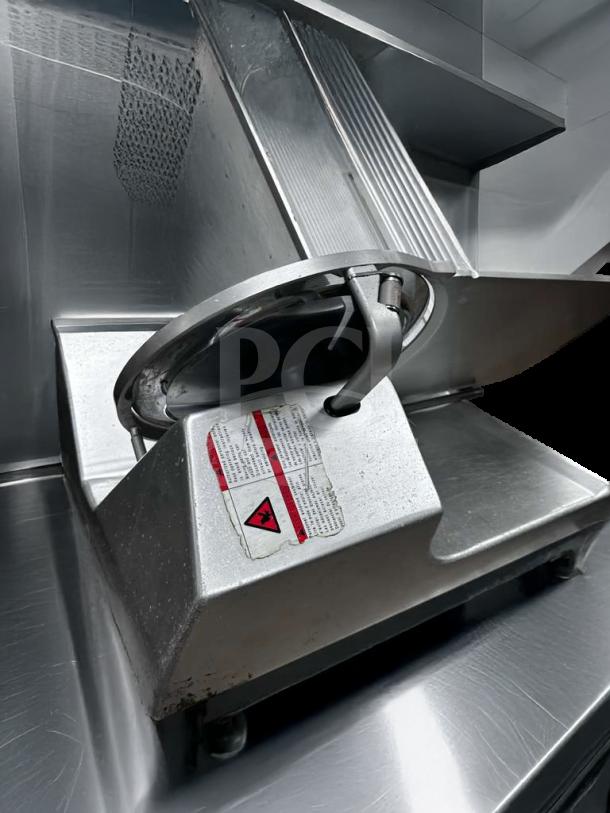 Pristine Bizerba GSP HD commercial meat slicer, heavy-duty, 120V, labeled warning and safety instructions, fully operational.