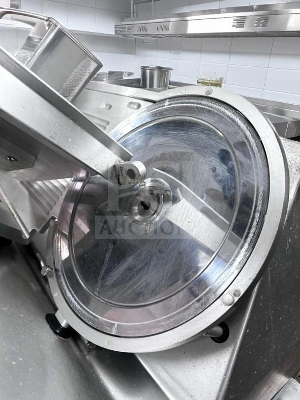 Bizerba GSP HD commercial meat slicer in pristine condition, showing stainless steel blade and components, fully operational.