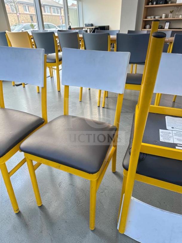 Commercial restaurant dining chairs, upholstered seat and back, heavy-duty metal frame, yellow and black design, model FUR-M-CHR-0583.