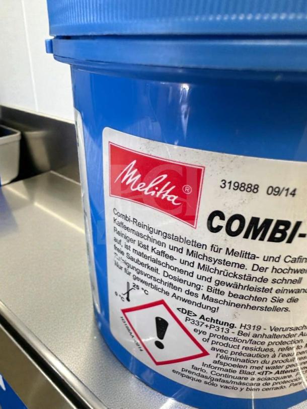 Blue container of Melitta COMBI-Tabs for Melitta & Cafina systems. Label includes safety warnings and usage instructions.