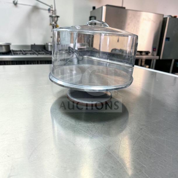 Acrylic cake display dome with stainless steel base, 12" diameter, generic commercial grade, premium condition, bakery use.