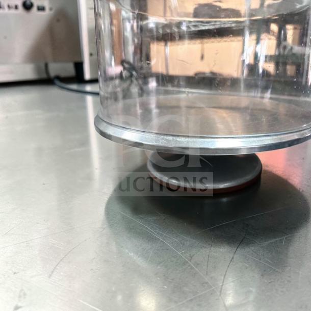 Acrylic cake display dome with stainless steel base, 12" diameter. Commercial grade, premium condition, ready for use.