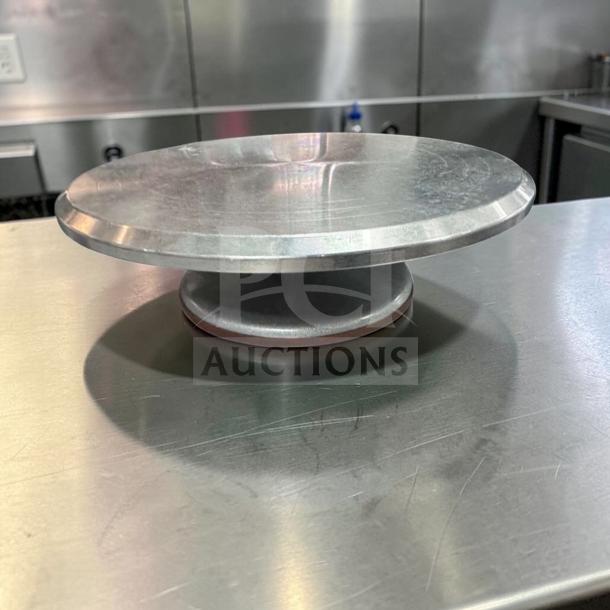 Stainless steel cake display base, 12" diameter, premium condition, commercial grade, ready for use.