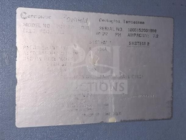 Metal label on Delfield 4427 undercounter refrigerator showing model, serial number, and manufacturing details.