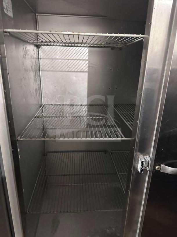 Traulsen G31310 reach-in freezer, 77" three-section, solid door, stainless steel, excellent condition, 208/115V, interior view.
