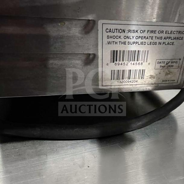 Label on Globe GSG14D Panini Grill showing caution details, barcode, and manufacture date: Sep 2020.