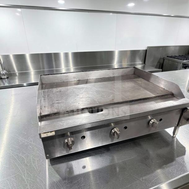 36" Commercial Gas Griddle in excellent condition, heavy-duty stainless steel, three knobs, fully tested and operational.