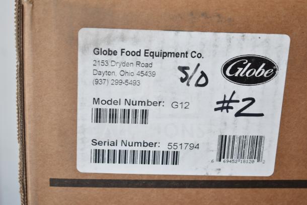 Label on the box for a Globe G12 commercial slicer, indicating model, serial number 551794, made by Globe Food Equipment Co.