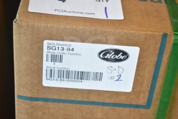 Box with label showing Globe SG13-84 commercial slicer details, marked new scratch and dent, serial SG13-84-000004.