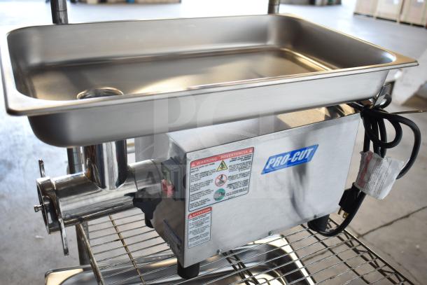 Brand new Pro-Cut OKG12SS Commercial Electric Meat Grinder, 115V, 1 Phase, visible labels with safety warnings, slight dents.
