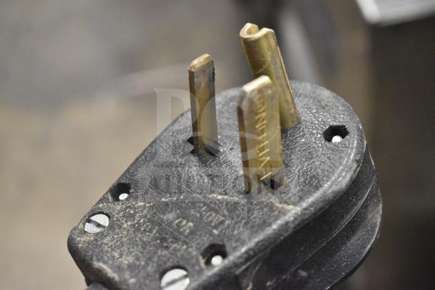 Close-up of a 208V, 1-phase plug for a 2019 Thermoplan Mastrena M2-CS espresso machine. Black casing, visible wear.
