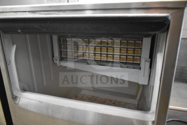 Hoshizaki KM-151BAH crescent cube ice machine, 115V, undercounter design. Interior view shows ice tray. Good condition.