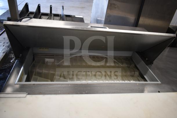 Beverage Air SPED60HC-08C-2 refrigerated prep table with cutting top, open lid showing storage area and dividers.