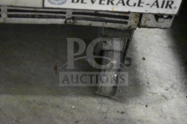 Beverage Air SPED60HC-08C-2 sandwich prep table on commercial casters. Visible branding, well-used condition.