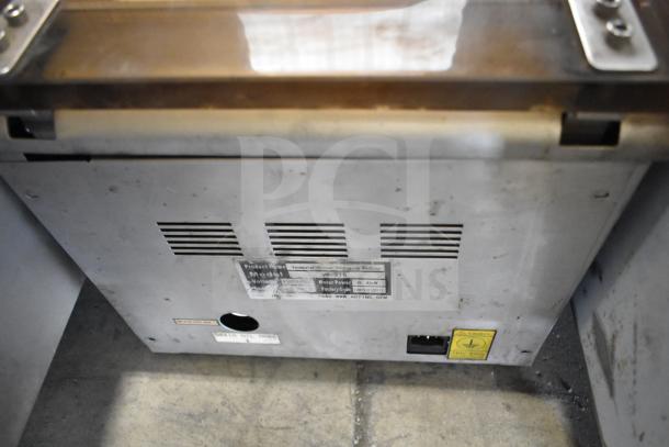 VacMaster VP-215 Chamber Vacuum Sealer with 10" seal bar, 120V, 1-phase. Metal casing shows wear. Labels detail model and voltage.