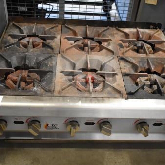 Cooking Performance Group 6 burner countertop gas range, used condition, with control knobs and visible wear. Model: CPG.