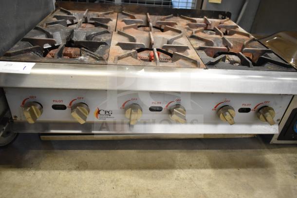 Cooking Performance Group 6-burner gas range, commercial countertop model. Features dials for pilot and heat control. Signs of use visible.