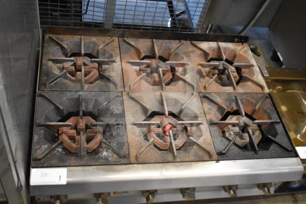 Cooking Performance Group CPG gas-powered 6-burner range, commercial countertop, worn condition, visible controls and burners.