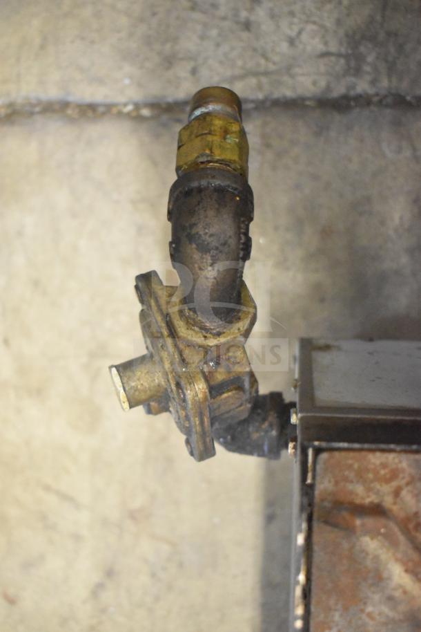 Gas valve connection of a Cooking Performance Group CPG Commercial Countertop 6 Burner Range, showing wear.