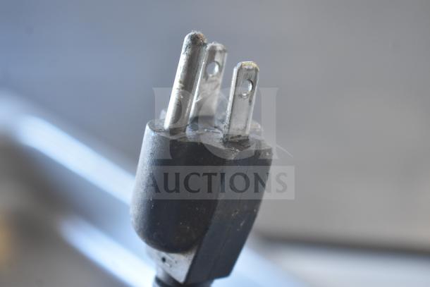 Close-up of a standard electrical plug for the Avantco 7700 Commercial Countertop Food Warmer, 120 Volts, 1 Phase.