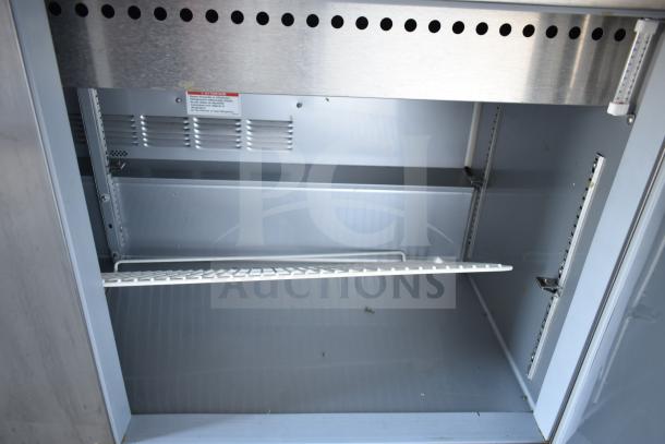 Beverage Air SPED60HC-08C-2 sandwich prep table interior, showing shelving and stainless steel finish.