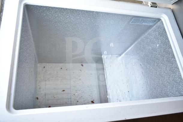 Vissani MDCF7WH chest freezer, 115 volts, 1 phase. Interior view showing slight wear and label with safety instructions.