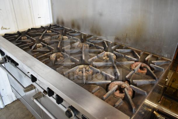 Garland SunFire X60-10RR commercial propane gas 10-burner range with 2 ovens, backsplash, and commercial casters. Used condition.