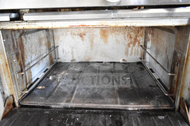 Garland SunFire X60-10RR commercial range oven, visible wear, 10 burners, 2 ovens, propane, on commercial casters.