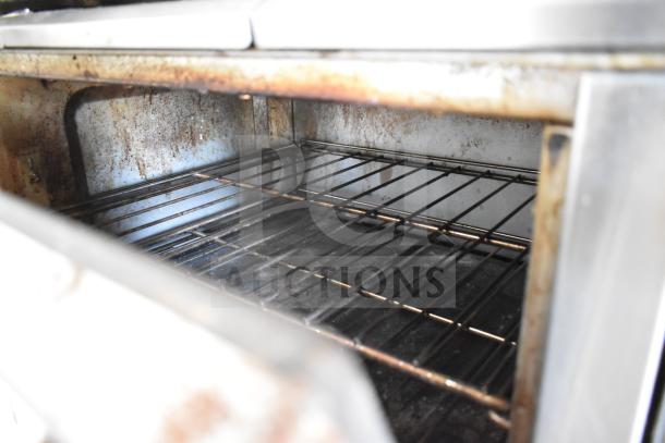 Garland SunFire X60-10RR oven interior showing wire racks, signs of use, and upper heating element.