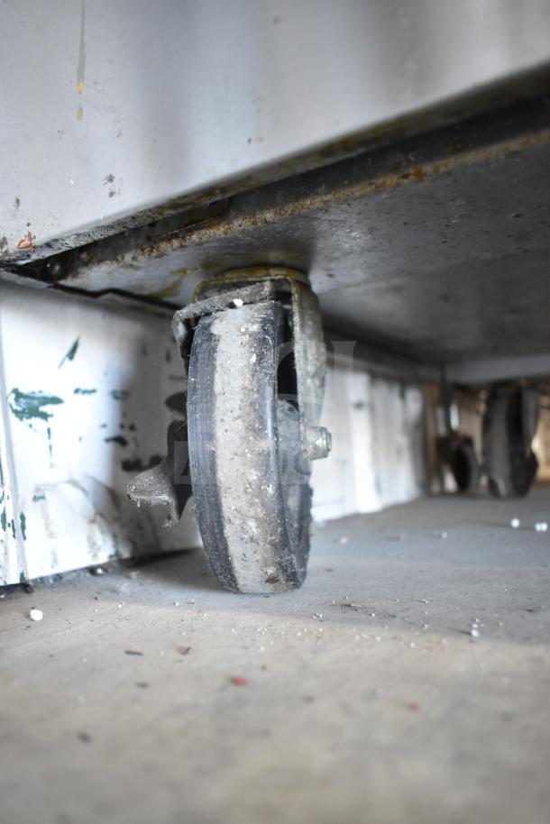Garland SunFire X60-10RR range on casters, showing a close-up of a wheel. Slight wear is visible on the caster.