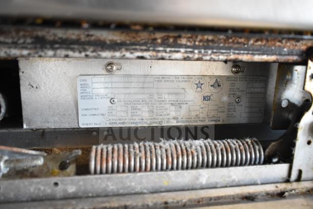 Garland SunFire X60-10RR commercial range label; details include model and specifications for propane gas operation.