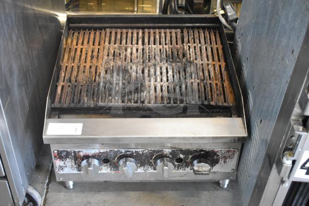 Commercial countertop gas charbroiler grill, steel construction, used condition, multiple heat control knobs, visible wear.