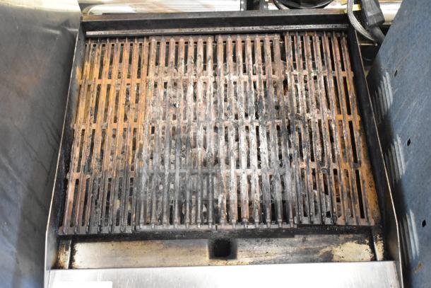 Commercial countertop gas charbroiler grill with used grates and visible wear, suitable for high-volume grilling.