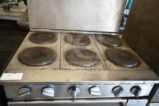 Imperial IR-6-E commercial 6 burner electric hot plate range with oven, back splash. Signs of wear, 208V, 3 phase.