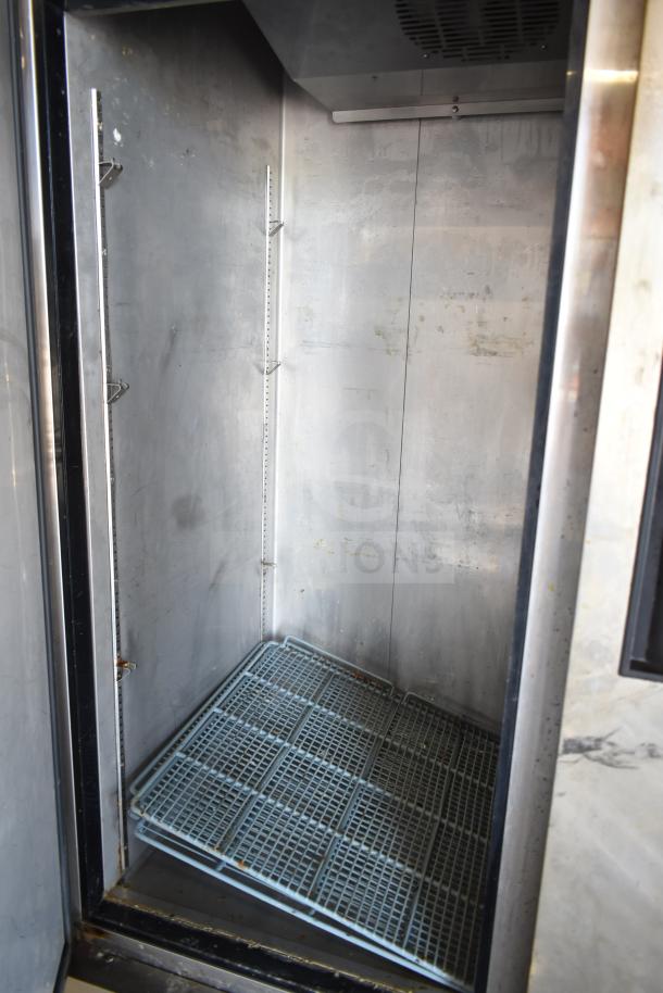 Dukers D55R Commercial 2 Door Reach In Cooler, 115 volts, 1 phase, interior view showing shelves and metal lining.