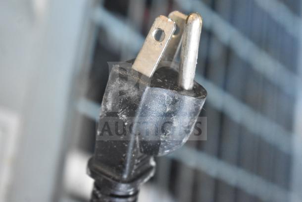 Power plug of Dukers D55R Commercial 2 Door Reach In Cooler, 115 volts, 1 phase. Close-up view of plug condition.
